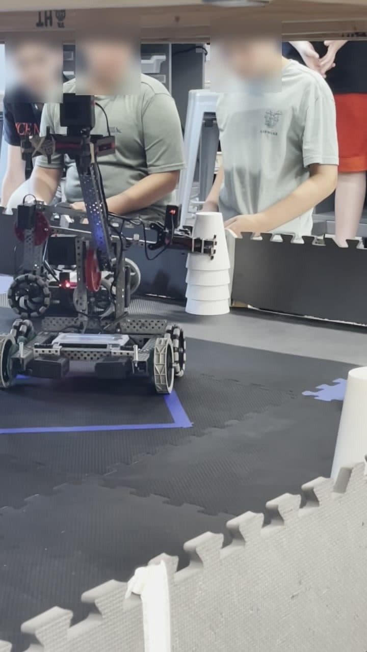 Close-up of a robot claw lifting cups