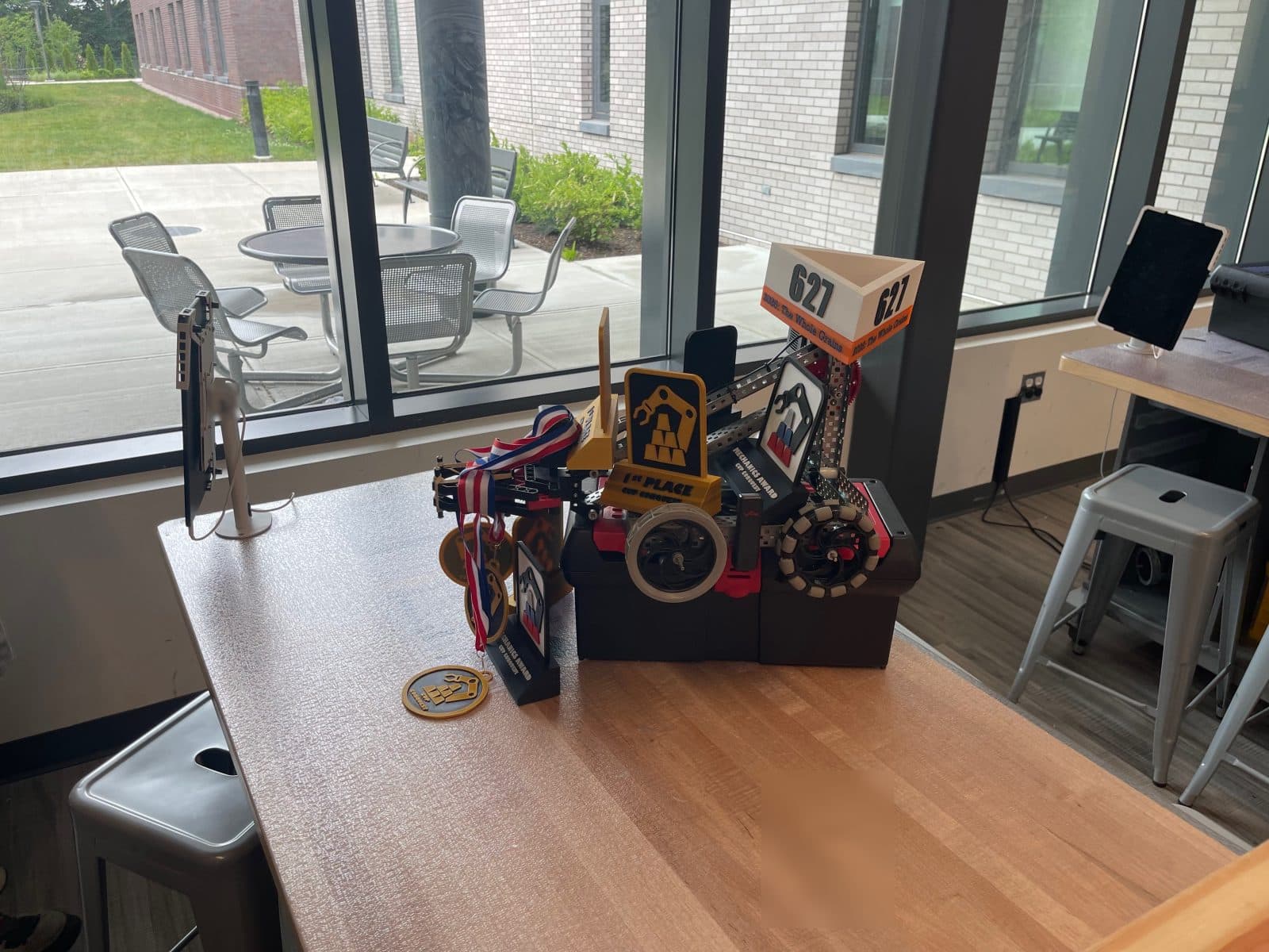 A winning robot displayed with medals and awards